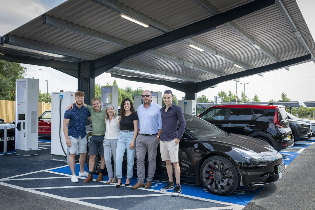 happy team infront of solar carport