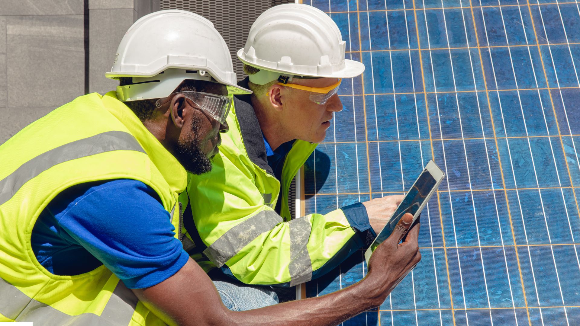 engineering experts reviewing a solar panel