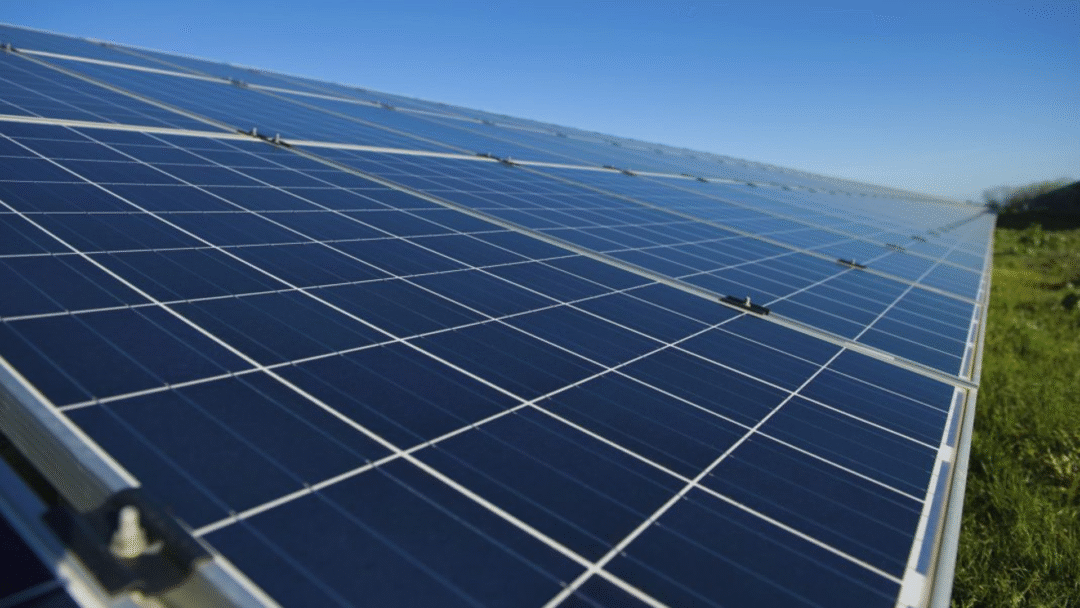 Close-up view of a large solar panel array under clear blue skies.