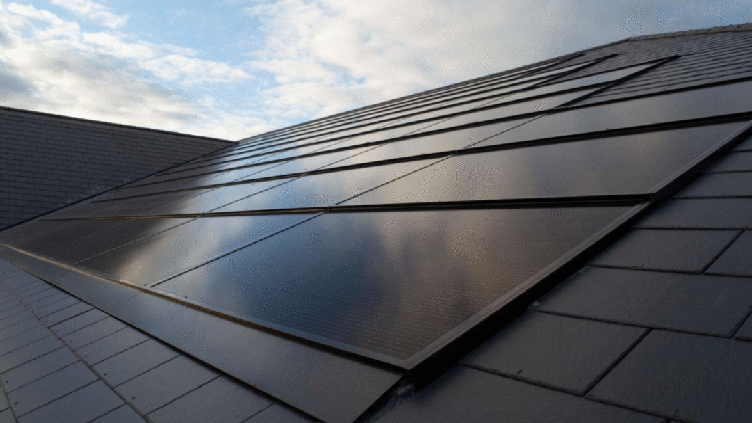 Black integrated solar panels installed flush with a pitched tiled roof.