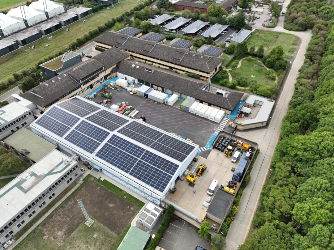 solar carport next to a research lab with solar panels on its roof