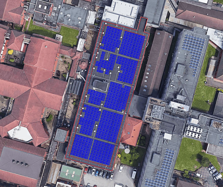 Aerial view of Heartland Hospital with a digital overlay showing the planned layout for the solar panel installation across the main rooftop.